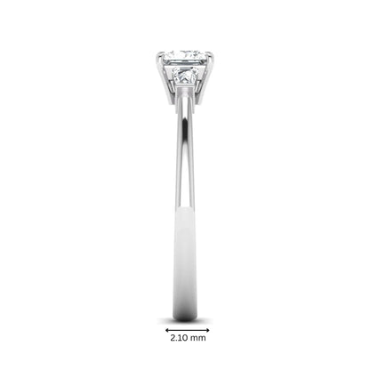 Princess cut lab grown diamond three stone engagement ring with tapered baguette side diamonds in a four-prong setting and white gold tone band.