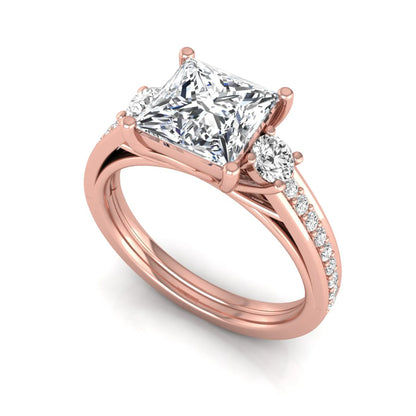 Princess cut three stone lab grown diamond engagement ring featuring a princess center diamond, round side diamonds, and pavé band in Rose metal tone.