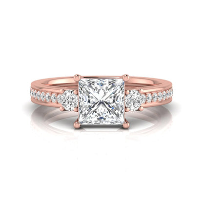Princess cut three stone lab grown diamond engagement ring featuring a princess center diamond, round side diamonds, and pavé band in Rose metal tone.