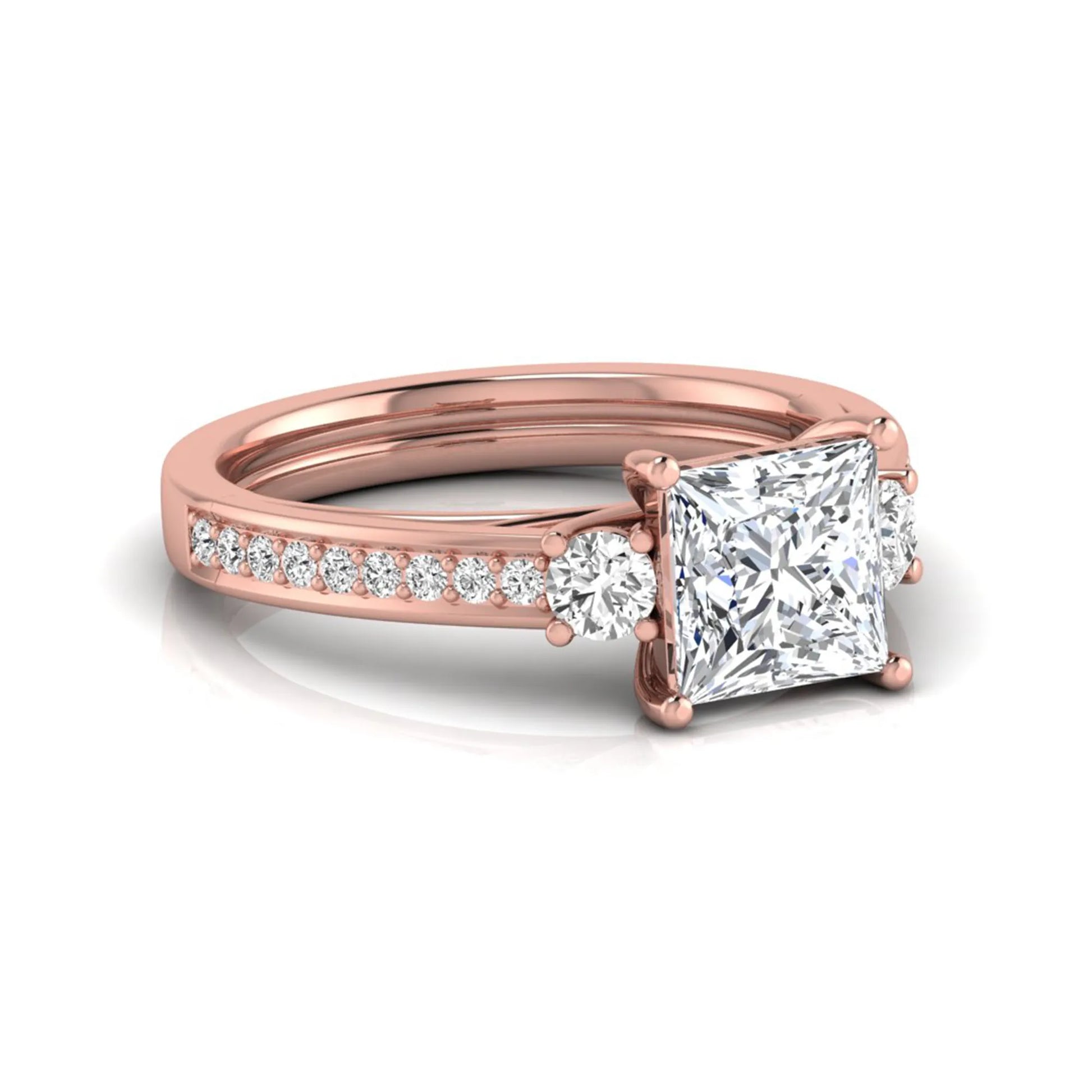 Princess cut three stone lab grown diamond engagement ring featuring a princess center diamond, round side diamonds, and pavé band in Rose metal tone.