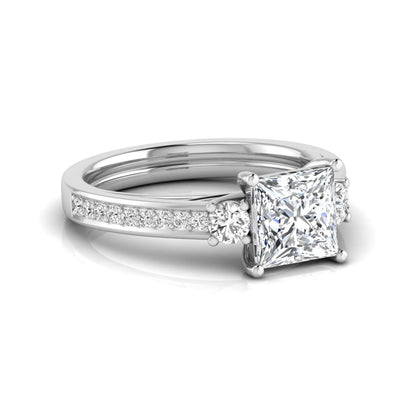 Princess cut three stone lab grown diamond engagement ring featuring a princess center diamond, round side diamonds, and pavé band in White metal tone.