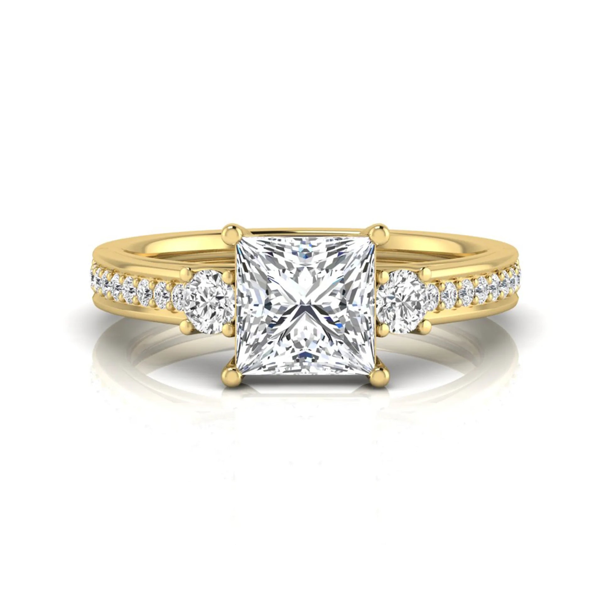 Princess cut three stone lab grown diamond engagement ring featuring a princess center diamond, round side diamonds, and pavé band in yellow metal tone.
