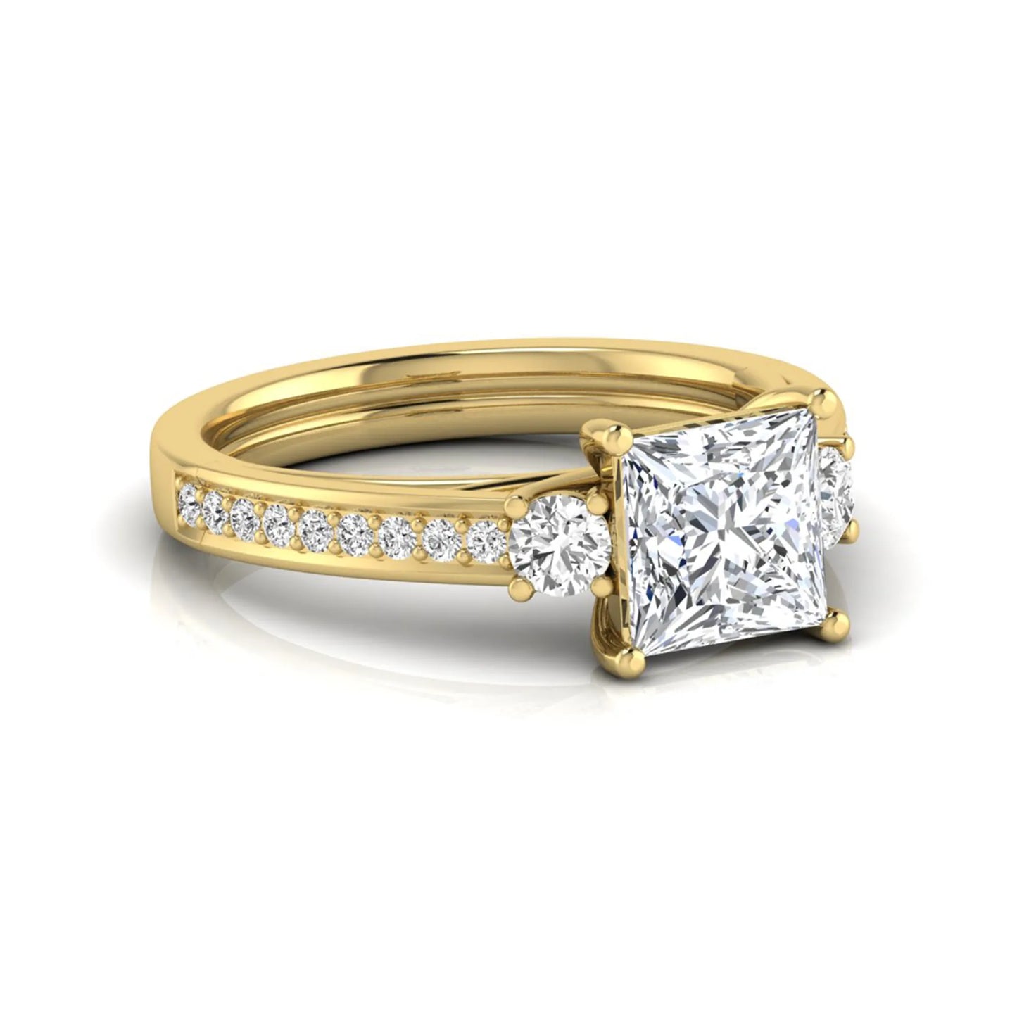Princess cut three stone lab grown diamond engagement ring featuring a princess center diamond, round side diamonds, and pavé band in yellow metal tone.