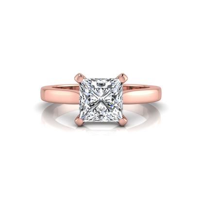 Rose-gold ring with a large diamond on a white background