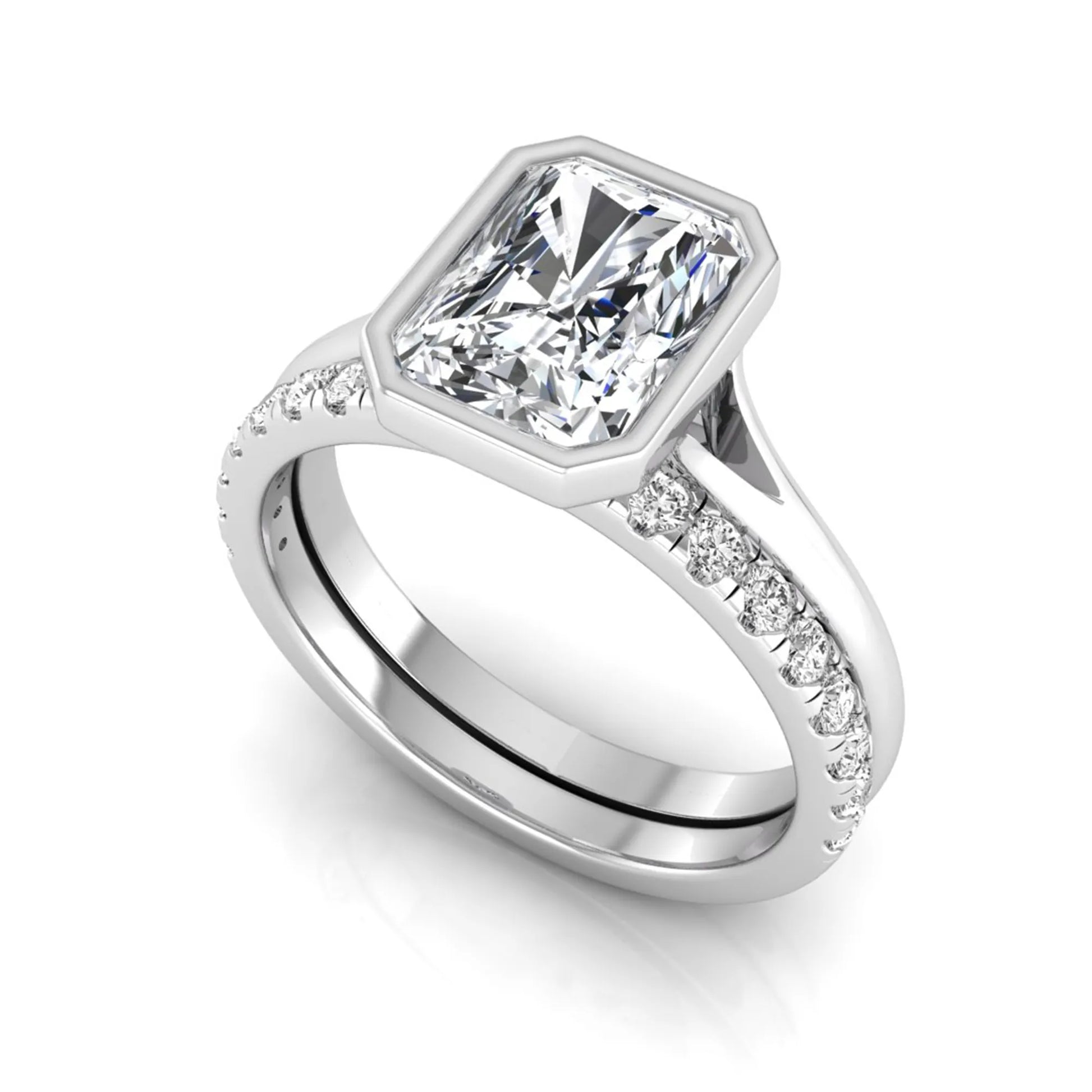 Radiant cut bezel set lab grown diamond bridal ring set with pavé contour band and white gold metal tone.