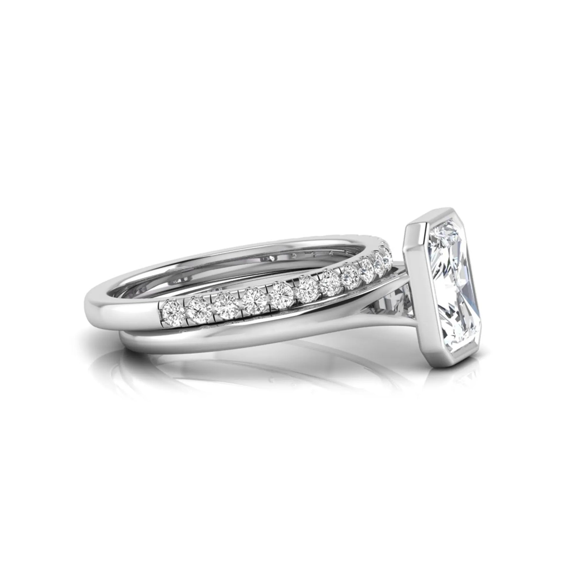 Radiant cut bezel set lab grown diamond bridal ring set with pavé contour band and white gold metal tone.