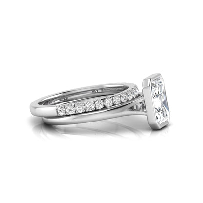 Radiant cut bezel set lab grown diamond bridal ring set with pavé contour band and white gold metal tone.