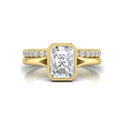 Radiant cut bezel set lab grown diamond bridal ring set with pavé contour band and yellow gold metal tone.