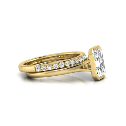 Radiant cut bezel set lab grown diamond bridal ring set with pavé contour band and yellow gold metal tone.