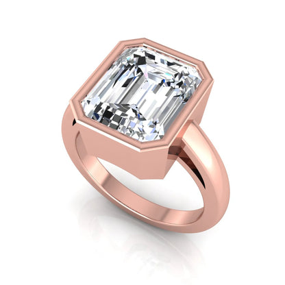Radiant cut bezel set lab grown diamond solitaire engagement ring with a rose gold tone band featuring an IGI certified center diamond.