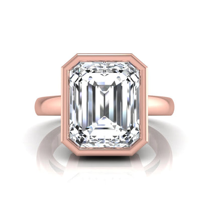 Radiant cut bezel set lab grown diamond solitaire engagement ring with a rose gold tone band featuring an IGI certified center diamond.