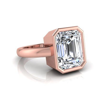 Radiant cut bezel set lab grown diamond solitaire engagement ring with a rose gold tone band featuring an IGI certified center diamond.