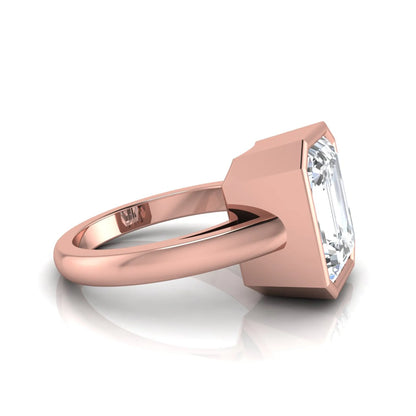 Radiant cut bezel set lab grown diamond solitaire engagement ring with a rose gold tone band featuring an IGI certified center diamond.