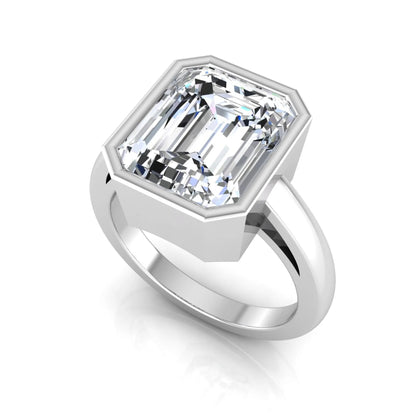 Radiant cut bezel set lab grown diamond solitaire engagement ring with a white gold tone band featuring an IGI certified center diamond.