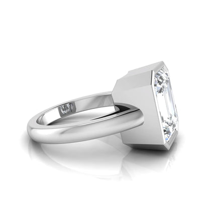 Radiant cut bezel set lab grown diamond solitaire engagement ring with a white gold tone band featuring an IGI certified center diamond.