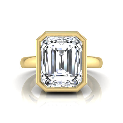 Radiant cut bezel set lab grown diamond solitaire engagement ring with a yellow gold tone band featuring an IGI certified center diamond.