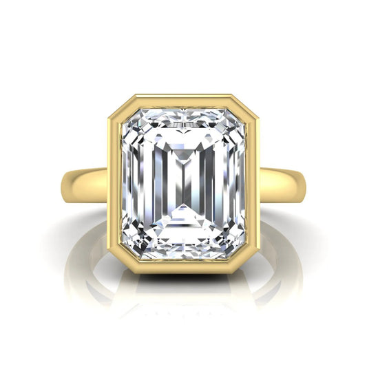 Radiant cut bezel set lab grown diamond solitaire engagement ring with a yellow gold tone band featuring an IGI certified center diamond.