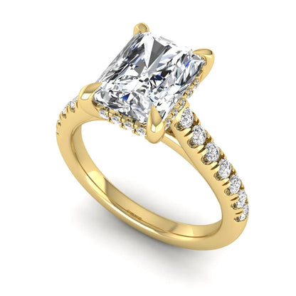 Radiant cut lab grown diamond hidden halo engagement ring with pavé diamond band and cathedral setting in yellow gold.