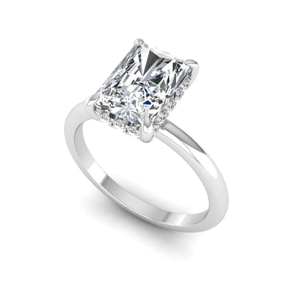 IGI certified radiant cut lab grown diamond hidden halo solitaire engagement ring in white gold with a four-prong setting.