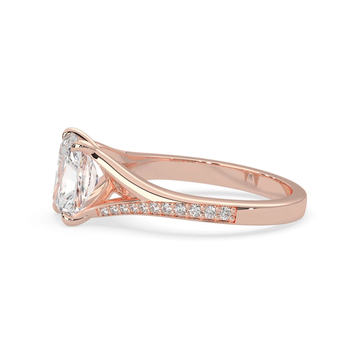 Rose gold ring with an emerald cut lab grown diamond and smaller diamonds on the band against a white background