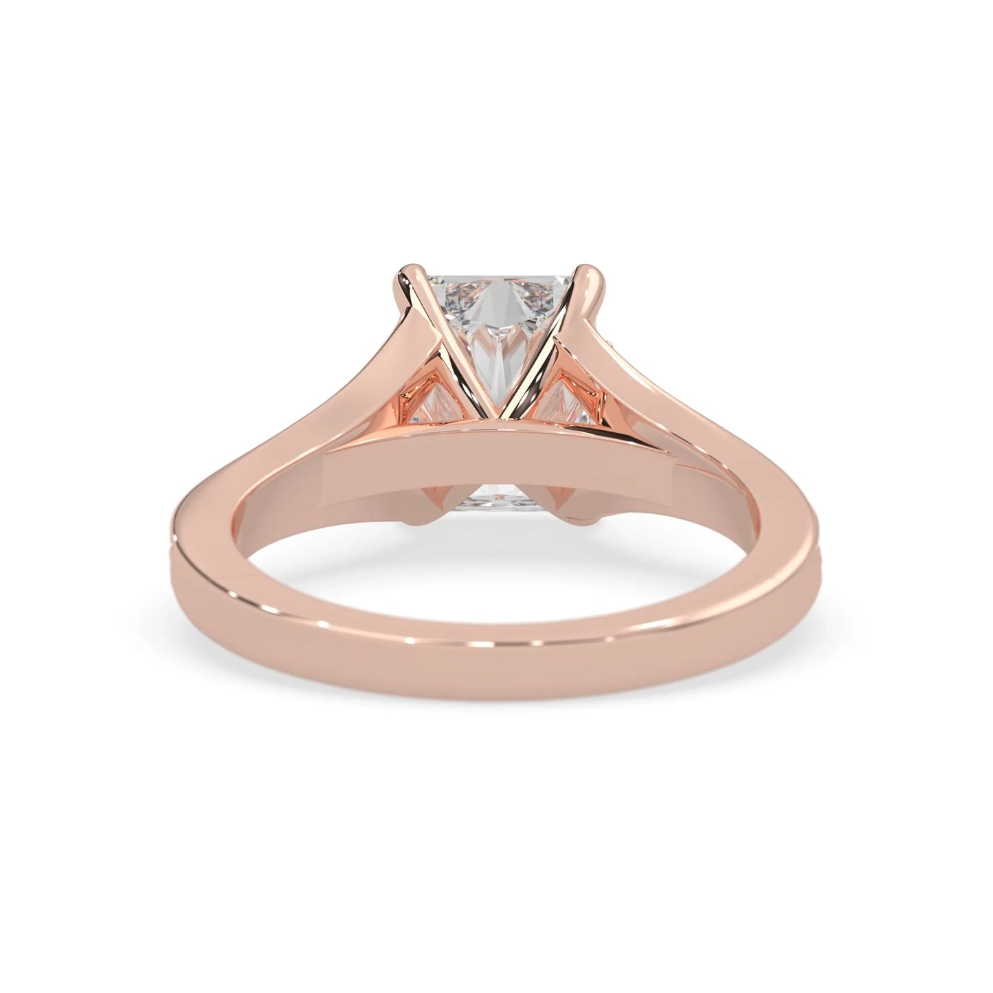 Rose gold ring with an emerald cut lab grown diamond and smaller diamonds on the band against a white background