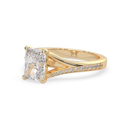 yellow Gold ring with a large lab grown  diamond and smaller diamonds on the band against a white background
