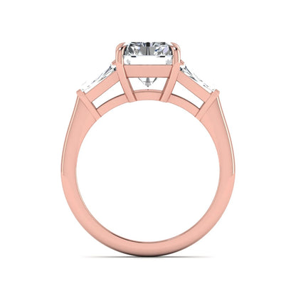 Radiant cut lab grown diamond three stone engagement ring with tapered baguette side diamonds and four prong setting in rose gold tone.