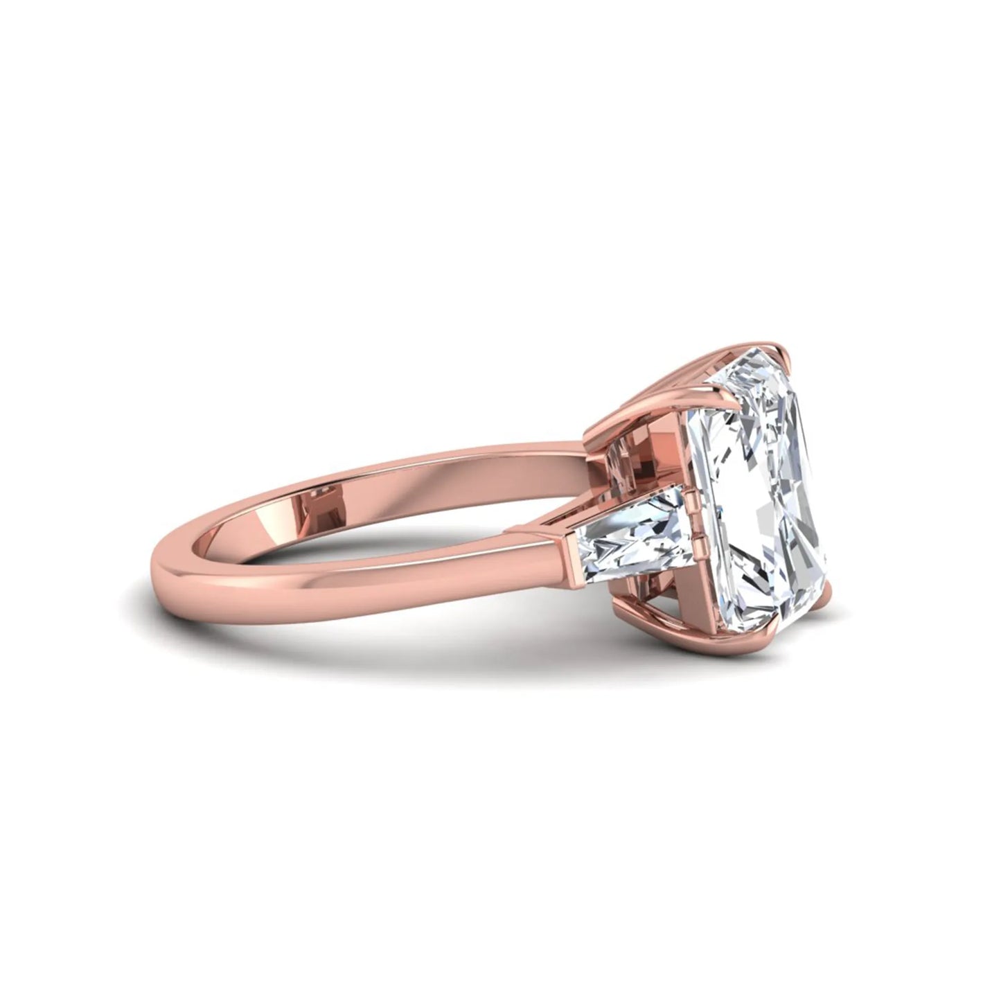 Radiant cut lab grown diamond three stone engagement ring with tapered baguette side diamonds and four prong setting in rose gold tone.