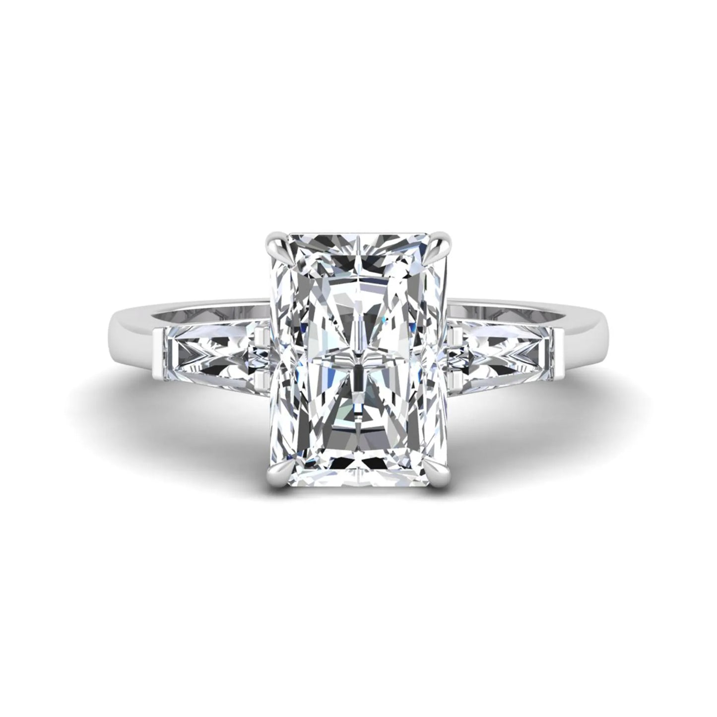 Radiant cut lab grown diamond three stone engagement ring with tapered baguette side diamonds and four prong setting in white gold tone.