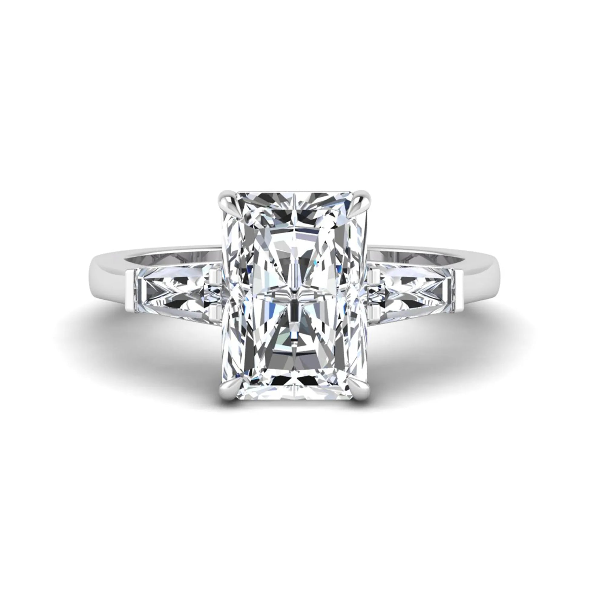 Radiant cut lab grown diamond three stone engagement ring with tapered baguette side diamonds and four prong setting in white gold tone.