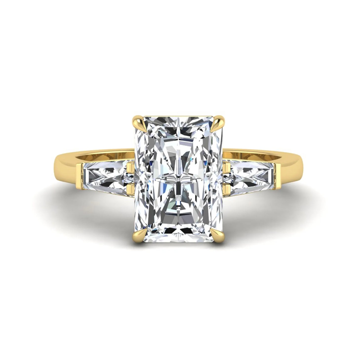 Radiant cut lab grown diamond three stone engagement ring with tapered baguette side diamonds and four prong setting in yellow gold tone.