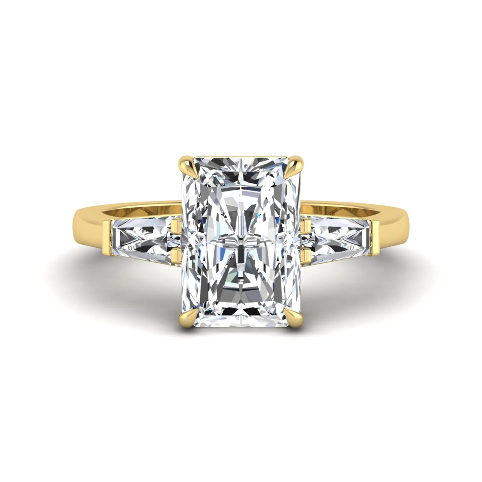 Radiant cut lab grown diamond three stone engagement ring with tapered baguette side diamonds and four prong setting in yellow gold tone.