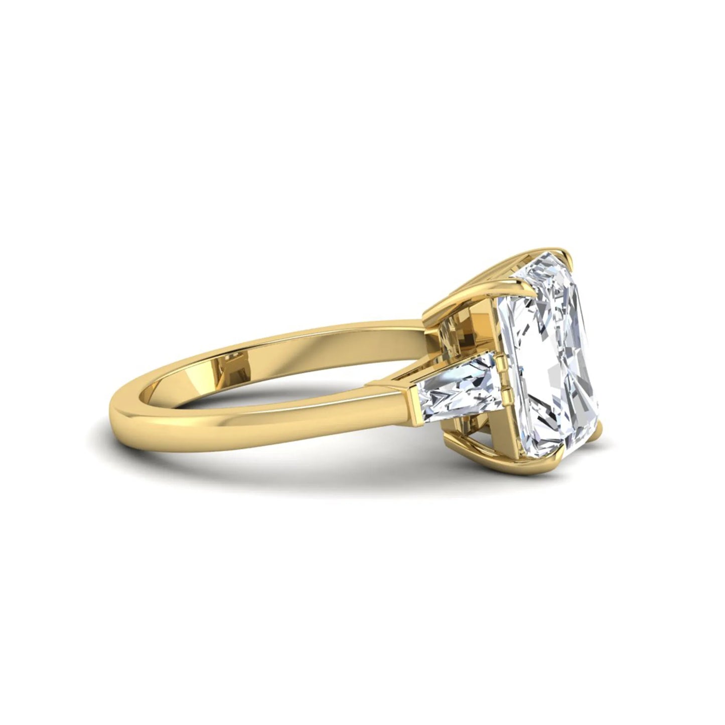 Radiant cut lab grown diamond three stone engagement ring with tapered baguette side diamonds and four prong setting in yellow gold tone.