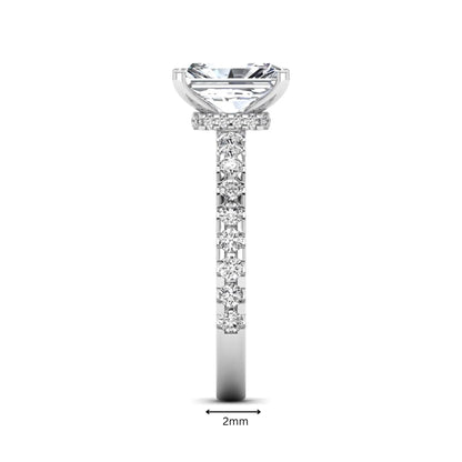 Radiant cut lab grown diamond hidden halo engagement ring featuring a four prong setting with pavé round diamond band in white gold tone.