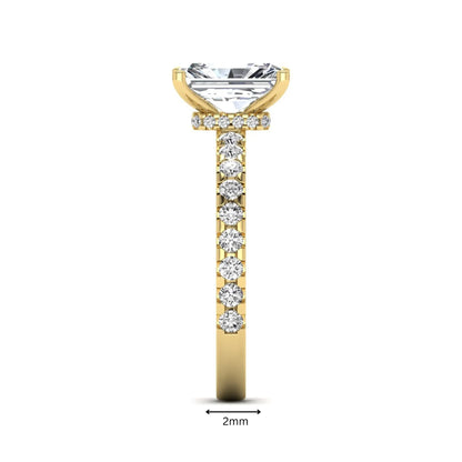 Radiant cut lab grown diamond hidden halo engagement ring featuring a four prong setting with pavé round diamond band in yellow gold tone.