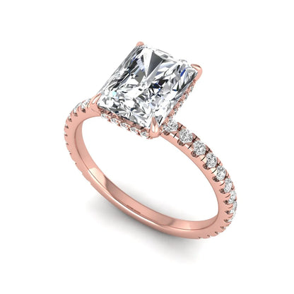 Radiant cut lab grown diamond hidden halo engagement ring featuring a four prong setting, pavé round diamonds, and rose gold tone design.