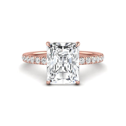 Radiant cut lab grown diamond hidden halo engagement ring featuring a four prong setting, pavé round diamonds, and rose gold tone design.