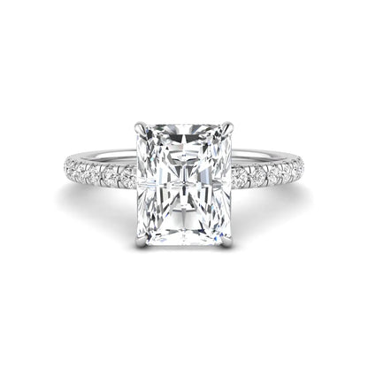 Radiant cut lab grown diamond hidden halo engagement ring featuring a four prong setting, pavé round diamonds, and white gold tone design.