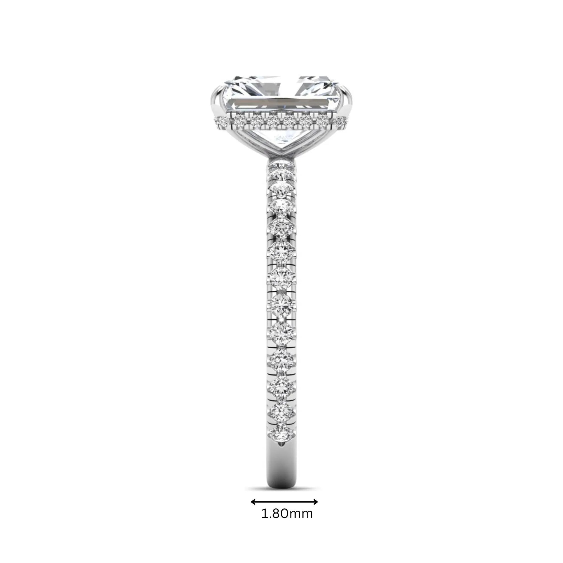 Radiant cut lab grown diamond hidden halo engagement ring featuring a four prong setting, pavé round diamonds, and white gold tone design.