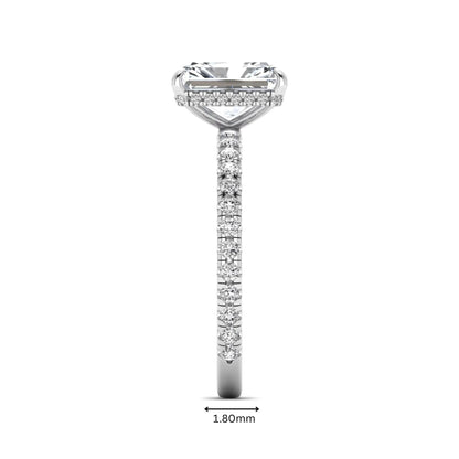 Radiant cut lab grown diamond hidden halo engagement ring featuring a four prong setting, pavé round diamonds, and white gold tone design.