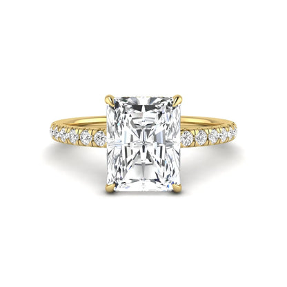Radiant cut lab grown diamond hidden halo engagement ring featuring a four prong setting, pavé round diamonds, and yellow gold tone design.