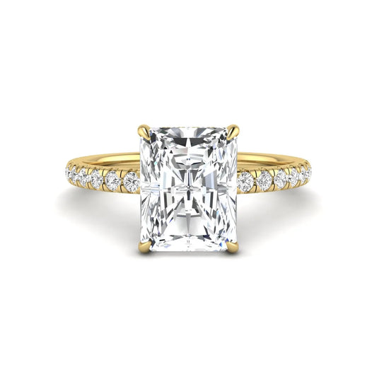 Radiant cut lab grown diamond hidden halo engagement ring featuring a four prong setting, pavé round diamonds, and yellow gold tone design.