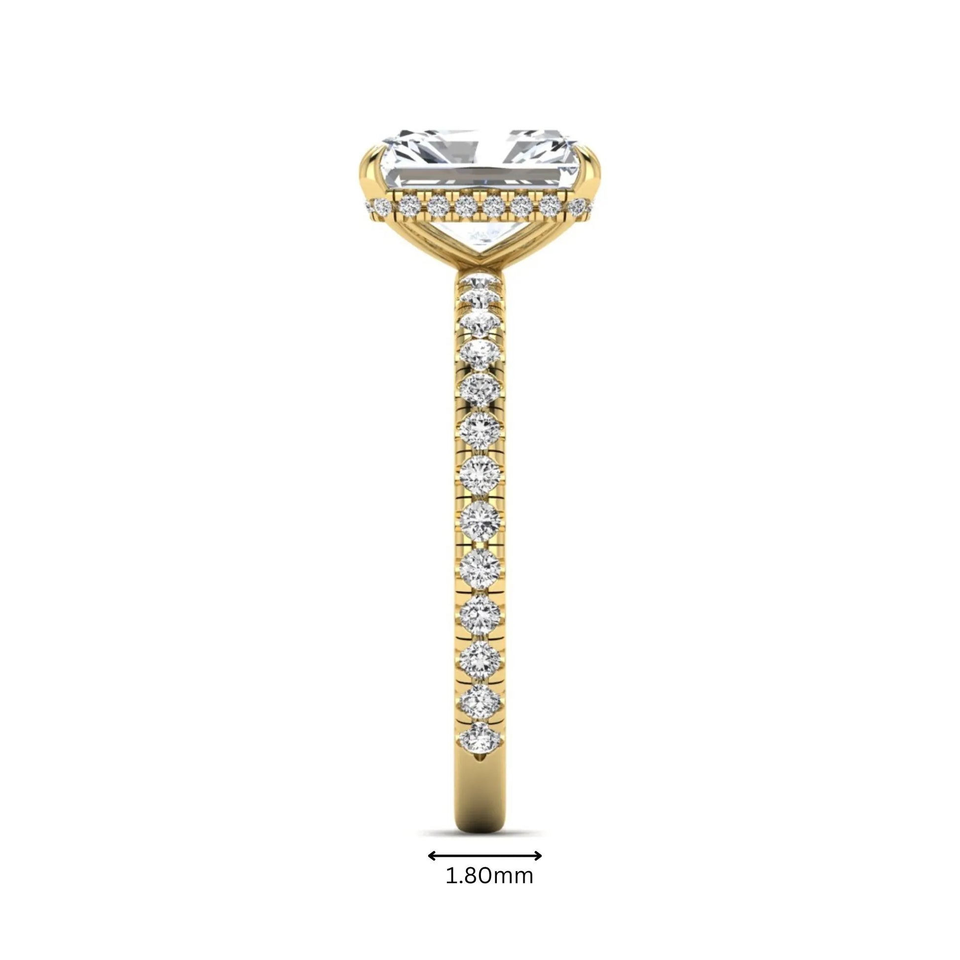 Radiant cut lab grown diamond hidden halo engagement ring featuring a four prong setting, pavé round diamonds, and yellow gold tone design.