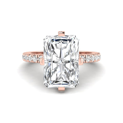Rose-gold ring with a large diamond and smaller diamonds on the band against a white background