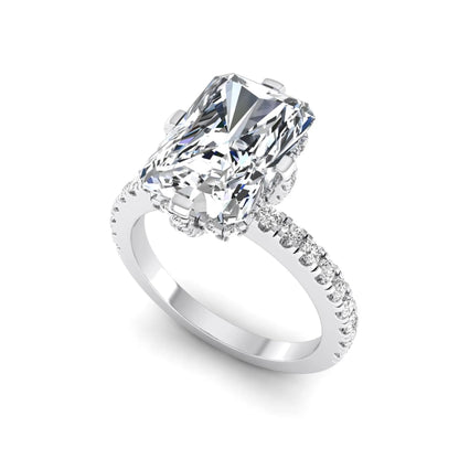 white-gold Diamond ring with a large central gemstone and smaller stones on the band against a white background