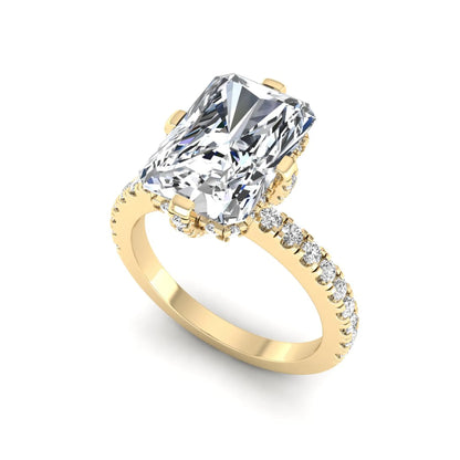 yellow-Gold ring with a large diamond and smaller diamonds on the band against a white background