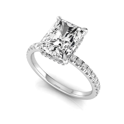 Radiant cut lab grown diamond engagement ring with hidden halo, pavé side diamonds, and four-prong setting in white gold style.