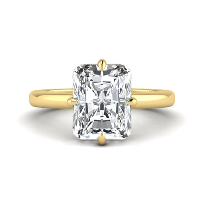 Radiant cut lab grown diamond hidden halo solitaire engagement ring with a four-prong setting and polished yellow gold band.