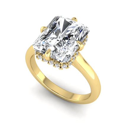 Radiant cut lab grown diamond hidden halo solitaire engagement ring with a four-prong setting and polished yellow gold band.