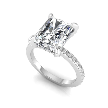 Radiant cut lab grown diamond solitaire engagement ring with hidden halo, pavé band, and white gold metal tone.